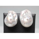 A LARGE PAIR OF BAROQUE PEARL EAR STUDS, the dove grey pearls inset with numerous small diamonds,