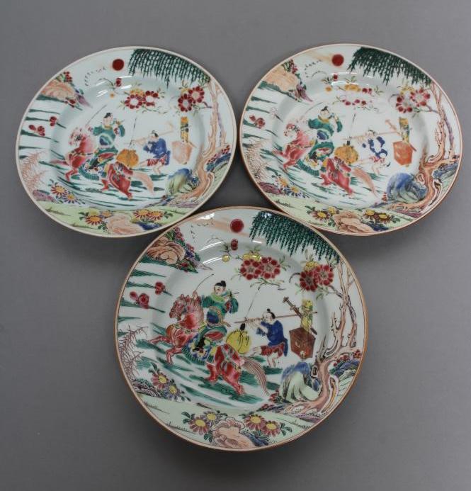 A SET OF THREE CHINESE PORCELAIN FAMILLE ROSE PLATES painted with a horseman fording a stream, his