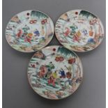 A SET OF THREE CHINESE PORCELAIN FAMILLE ROSE PLATES painted with a horseman fording a stream, his