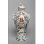 A CHINESE PORCELAIN VASE AND COVER of inverted baluster form, the two fixed ring handles with mask
