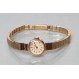 A LADY'S 9CT GOLD LONGINES WRISTWATCH, the champagne dial with applied gilt metal batons, the