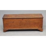 AN OAK BOARDED CHEST, c.1800, the hinged lid with moulded edge now opening to a void interior,