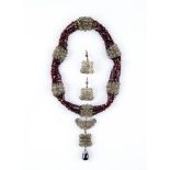A BOHEMIAN GARNET BEAD FOUR STRING NECKLACE, 19th century, with silver gilt filigree square clasp