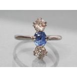 A SAPPHIRE AND DIAMOND THREE STONE RING, the stones claw set vertically to an unmarked white