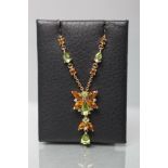 A BUTTERFLY PENDANT with citrine wings and peridot head and thorax, with diamond points between,