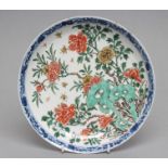 A CHINESE PORCELAIN SAUCER DISH of plain circular form, painted in colours with rockwork and