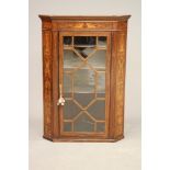 A MAHOGANY CORNER CUPBOARD, c.1900, the moulded cornice over astragal glazed door enclosing shaped