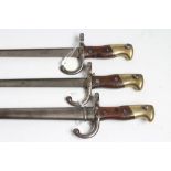 THREE M1874 FRENCH BAYONETS, all with back blade inscriptions, two piece wood grips and one with