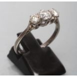 A THREE STONE DIAMOND RING, the central old cut stone of approximately 0.30cts flanked by two