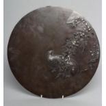A JAPANESE BRONZE ROUNDEL, late 19th century, cast in relief with two quail beneath leafy