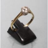 A SOLITAIRE DIAMOND RING, the old brilliant cut stone of approximately 0.80cts, claw set to a