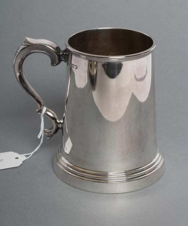 A SILVER MUG, maker Viners, Sheffield 1942, of tapering cylindrical form with double C scroll handle