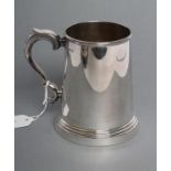 A SILVER MUG, maker Viners, Sheffield 1942, of tapering cylindrical form with double C scroll handle