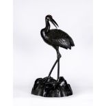 A JAPANESE BRONZE CRANE CENSOR, c.1900, the dark patinated bird with red cresting, a small lift-