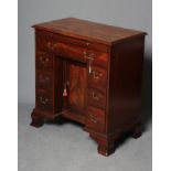 A GEORGIAN MAHOGANY KNEEHOLE CHEST, third quarter 18th century, the moulded edged top over slide and