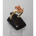 A TOPAZ AND DIAMOND DRESS RING, the Princess cut pale brown topaz print set to shoulders each with