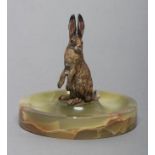 AN ART DECO COLD PAINTED SPELTER HARE, fixed onto a green onyx dished stand, hare 3 1/2" high,