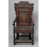 A VICTORIAN JOINED OAK ARM CHAIR in the late 17th century style, with inlaid zig zag banding, the