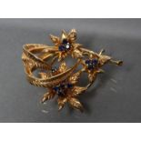 A 9CT GOLD TRIPLE SPRAY BROOCH, the flowers with claw set sapphire centres, Birmingham 1975 (Est.