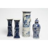 A PAIR OF CHINESE PORCELAIN GU VASES painted in underglaze blue with prunus on a dark shaded ground,