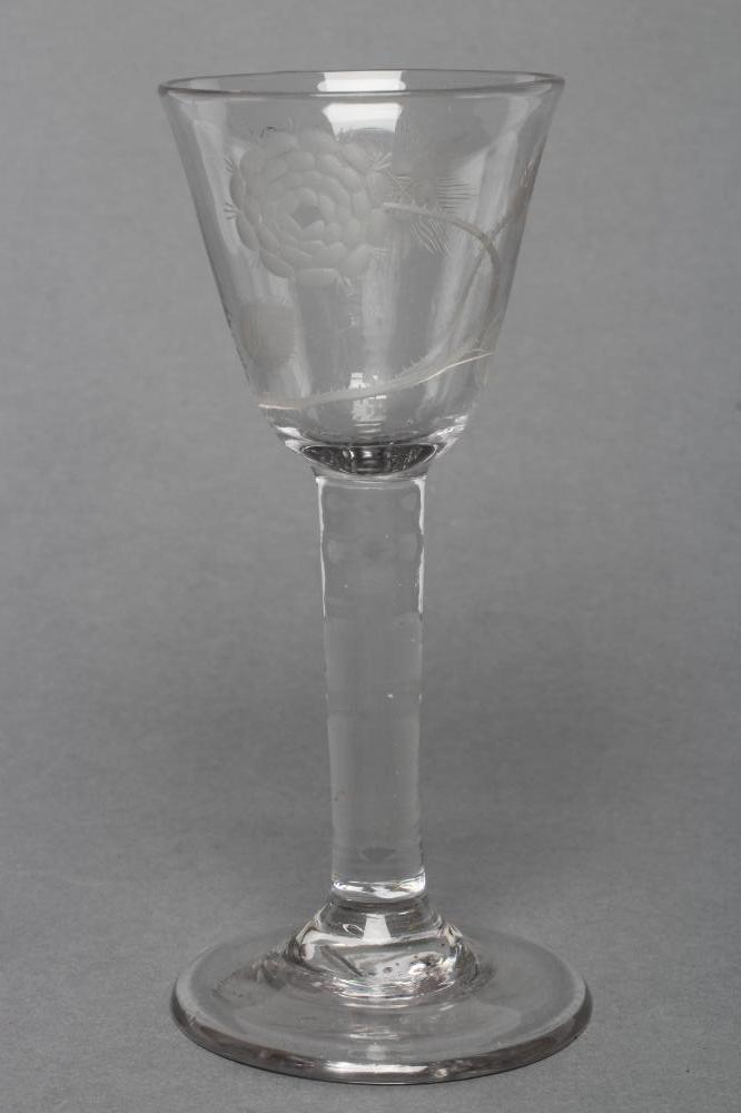 A JACOBITE WINE GLASS, mid 18th century, the round funnel bowl engraved with a rose, bud and a star,