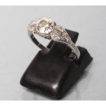 AN ART DECO DIAMOND RING, the brilliant cut centre stone claw set to shaped triangular shoulders