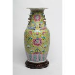 A CHINESE PORCELAIN VASE of baluster form with everted shaped rim and two shi-shi handles, painted