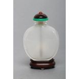A CHINESE WHITE CRYSTAL SNUFF BOTTLE, 2 1/4" high, the domed stopper inset with a cornelian bead and