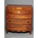 A REGENCY MAHOGANY BOW FRONT CHEST of four graduated drawers with turned wood handles, string inlaid