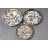 A CHINESE PORCELAIN FAMILLE ROSE SAUCER painted with three figures in a garden within a blue and