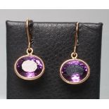 A PAIR OF AMETHYST DROP EARRINGS, the oval facet cut stones collet set to shepherd's hooks, unmarked