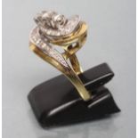 A DIAMOND DRESS RING diagonally set with three stones to an open whorl pave set with numerous