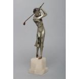 AN ART DECO SILVERED SPELTER LADY GOLFER FIGURE standing on a stepped white onyx base, unsigned, 11"