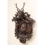 A LARGE BLACK FOREST CUCKOO CLOCK, 19th century, the two train movement striking on a gong, the case