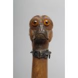 A LATE VICTORIAN HORN LETTER OPENER, the finial carved as a pug's head with amber glass eyes and