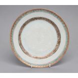 A CHINESE EXPORT PORCELAIN PLATE of plain circular form, with blanc-de-chine enamelled foliate