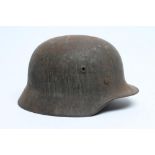 A GERMAN THIRD REICH M35 HELMET of typical form, with twin air vents and leather webbing, 11 1/2"