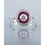 AN ART DECO STYLE DIAMOND AND RUBY DRESS RING, the central collet set brilliant cut stone of