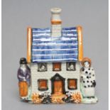 A MEXBOROUGH TYPE PRATTWARE PEARLWARE MONEY BOX, early 19th century, the two storey house flanked by