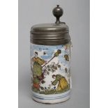 A GERMAN FAIENCE STEIN, mid 18th century, of plain cylindrical form painted in colours with a