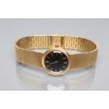 A LADY'S 18CT GOLD CHOPARD WRISTWATCH, the matt black "linen" dial with applied gilt metal batons,