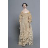 A papier mache doll, c.1840, shoulder head with moulded hair and painted features, shaped and