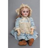 A Tete Jumeau bisque socket head doll, with blue glass sleeping eyes, open mouth, moulded teeth,