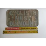 A cast iron Cyclist Must Dismount sign and two small Dunlop tin accessory signs (Est. plus 21%