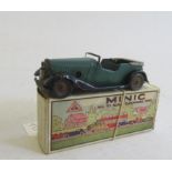 Triang Minic clockwork learner's car in green, motor AF, replacement seats in reproduction box, some