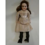 An Armand Marseille bisque shoulder head doll, with brown glass sleeping eyes, open mouth, teeth,