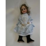 An SFBJ bisque socket head doll, with brown glass sleeping eyes, open mouth, teeth, light brown wig,