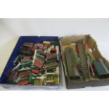 Unboxed post war clockwork Hornby trains with Type 101 locomotive, goods trucks and coaches, a
