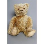 A pre-war German long haired jointed teddy bear, with orange plush, amber glass eyes, sewn nose,