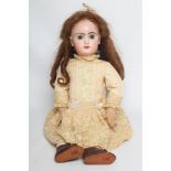 A Tete Jumeau bisque socket head doll, with blue glass fixed eyes, closed mouth, pierce ears,